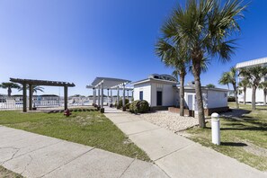 Relax in a tropical setting with ocean views from this beachfront property, featuring a covered outdoor area with a pergola.