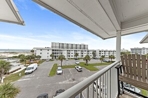 Enjoy the ocean views from this hotel's balcony, featuring a chair and railing.