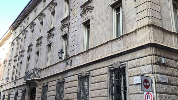 A historic building with classical architecture, including ornate window frames and a balcony. - Il Bosco Segreto, where magic and history come together (Torino)