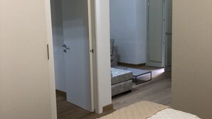 A room with a bed, a small table, a chair, and a wardrobe. - Il Bosco Segreto, where magic and history come together (Torino)