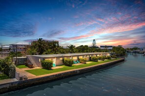 A waterfront hotel with a pool, a covered outdoor area, and a view of the water. - 4. Cozy Key Largo Waterfront Studio  Dive (Key Largo)