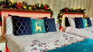 A bedroom with two beds, striped wallpaper, and Christmas decorations. - FINN VILLAGE Mountain View Cottage Garden & XXL HOT TUB (Glasgow)