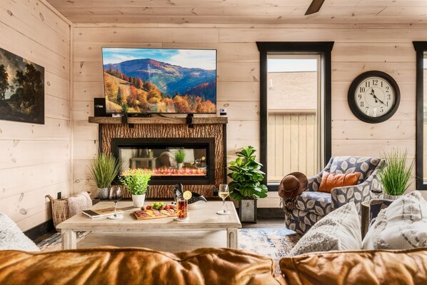 A cozy living room with a fireplace, a television, and comfortable seating.