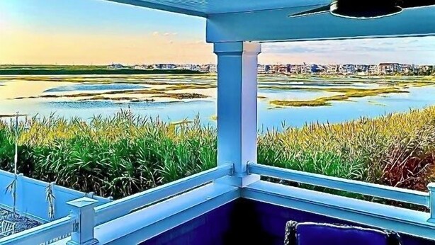 A room with a view of a water body and distant buildings. - Stunning  Townhome, Private Elevator, Expansive Bay Views! (Sea Isle City)
