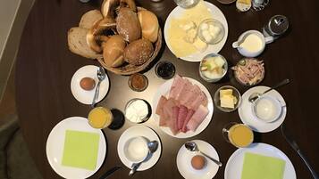 A breakfast buffet with various food items and condiments.