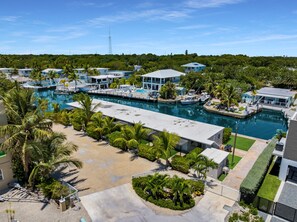 A resort with a marina, swimming pool, and lush greenery. - 5. Key Largo Waterfront Apartment | Reef & Relax (Key Largo)