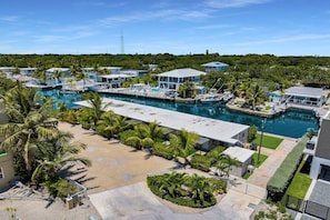 A marina with boats, a swimming pool, and a resort area with palm trees. - 6. Key Largo Waterfront Studio / Dock / Snorkel (Key Largo)