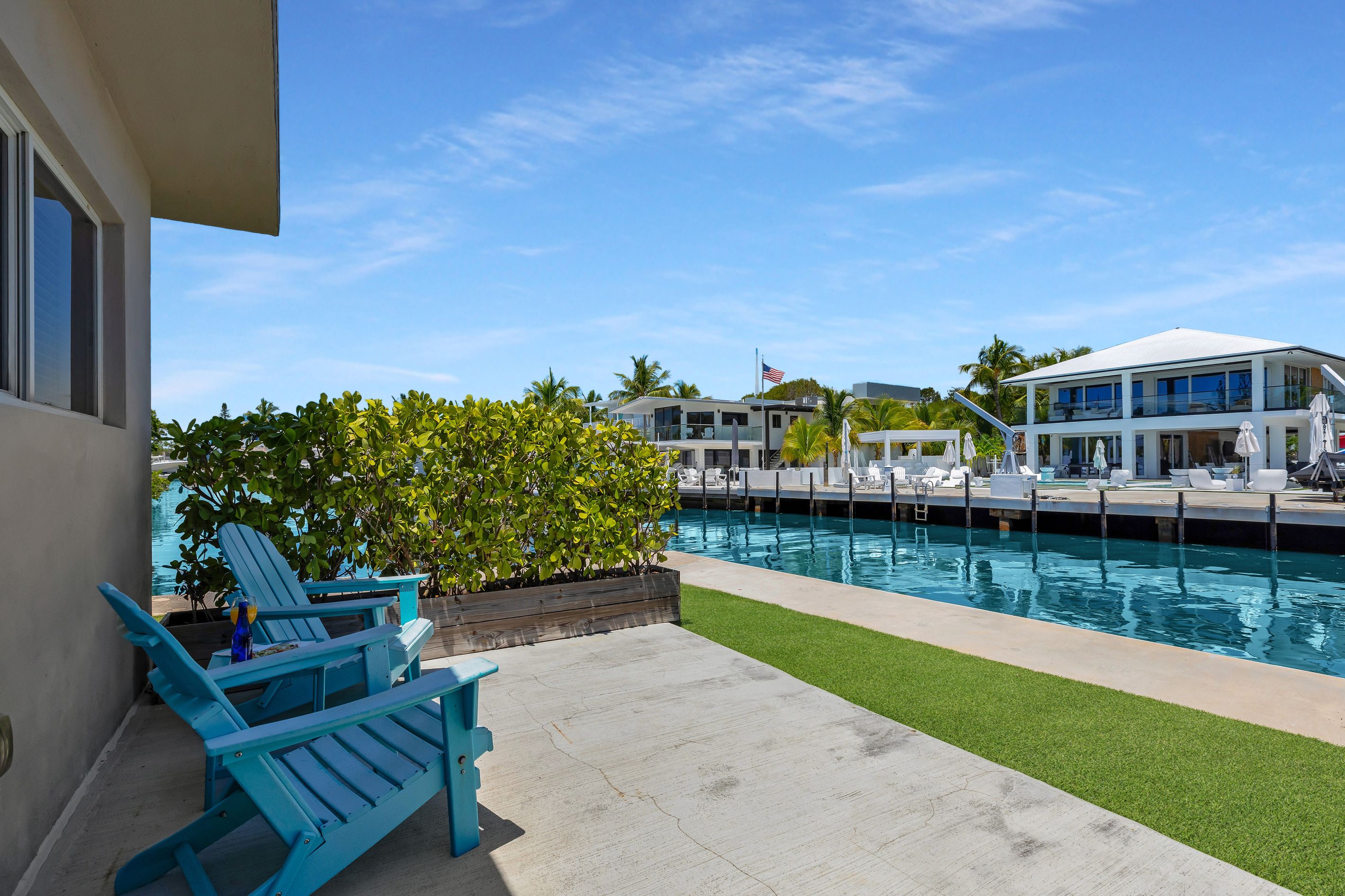 A swimming pool with lounge chairs and a building in the background.