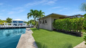 A residential property with a swimming pool, a covered patio, and a well-maintained lawn. - 6. Key Largo Waterfront Studio / Dock / Snorkel (Key Largo)
