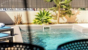 A pool area with lounge chairs and a cactus plant. - Villa Nueva-Tourist accommodation 3*-Private pool (Saint-Pierre)