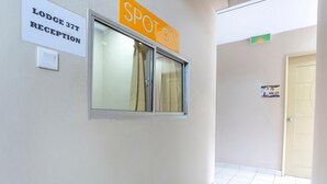 A hallway with a reception sign for 'Lodge 37T' and a 'Spot On' sign above a window. - Lodge 37T (Ranau)