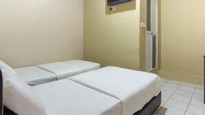 A room with two single beds, a television mounted on the wall, and an air conditioning unit above the beds. - Lodge 37T (Ranau)
