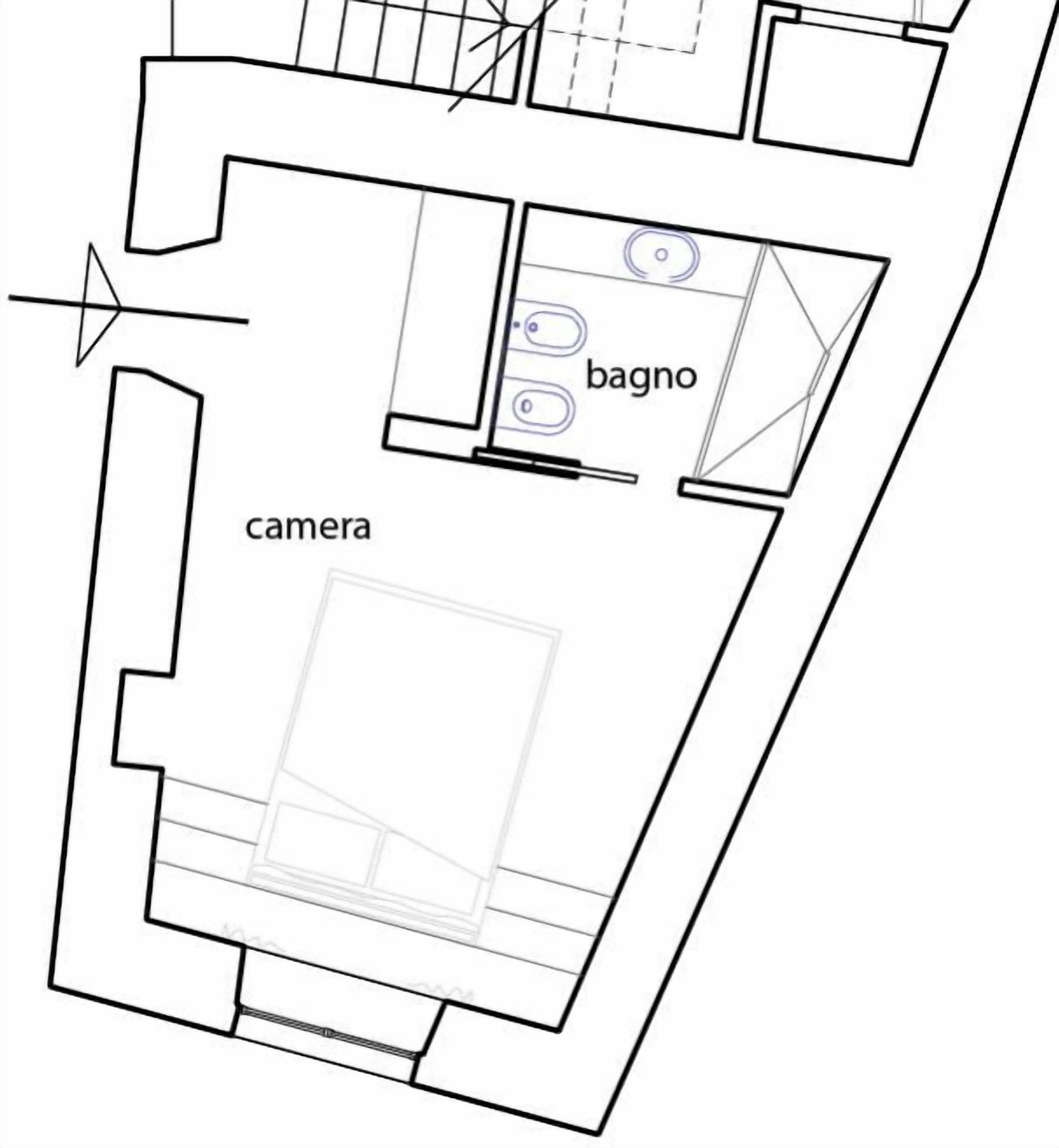 A floor plan with a kitchen area labeled 'bagno' and a room labeled 'camera.'
