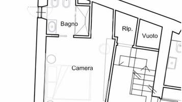 Un plan d’étage avec des pièces identifiées par des étiquettes, notamment une chambre, une salle de bain, un débarras et un espace vide.