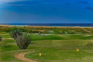 A golf course with a view of the ocean. - Perfect for Groups! 7BR Villa w/ Pool, Ocean Views (Noord)