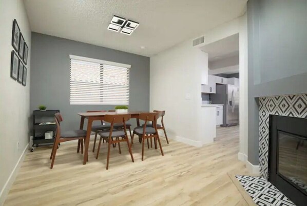 Enjoy meals in the dining area with a wooden table and comfortable seating.