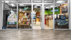 A store entrance with signs for 'Superfoods', 'Organic', 'Healthy', and 'Lifestyle'. - MIA Edgewater with sea view. (Miami)
