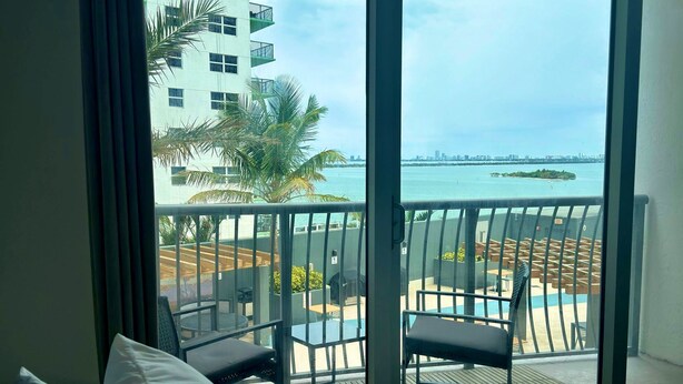 A balcony with a view of the sea and a city skyline. - MIA Edgewater with sea view. (Miami)