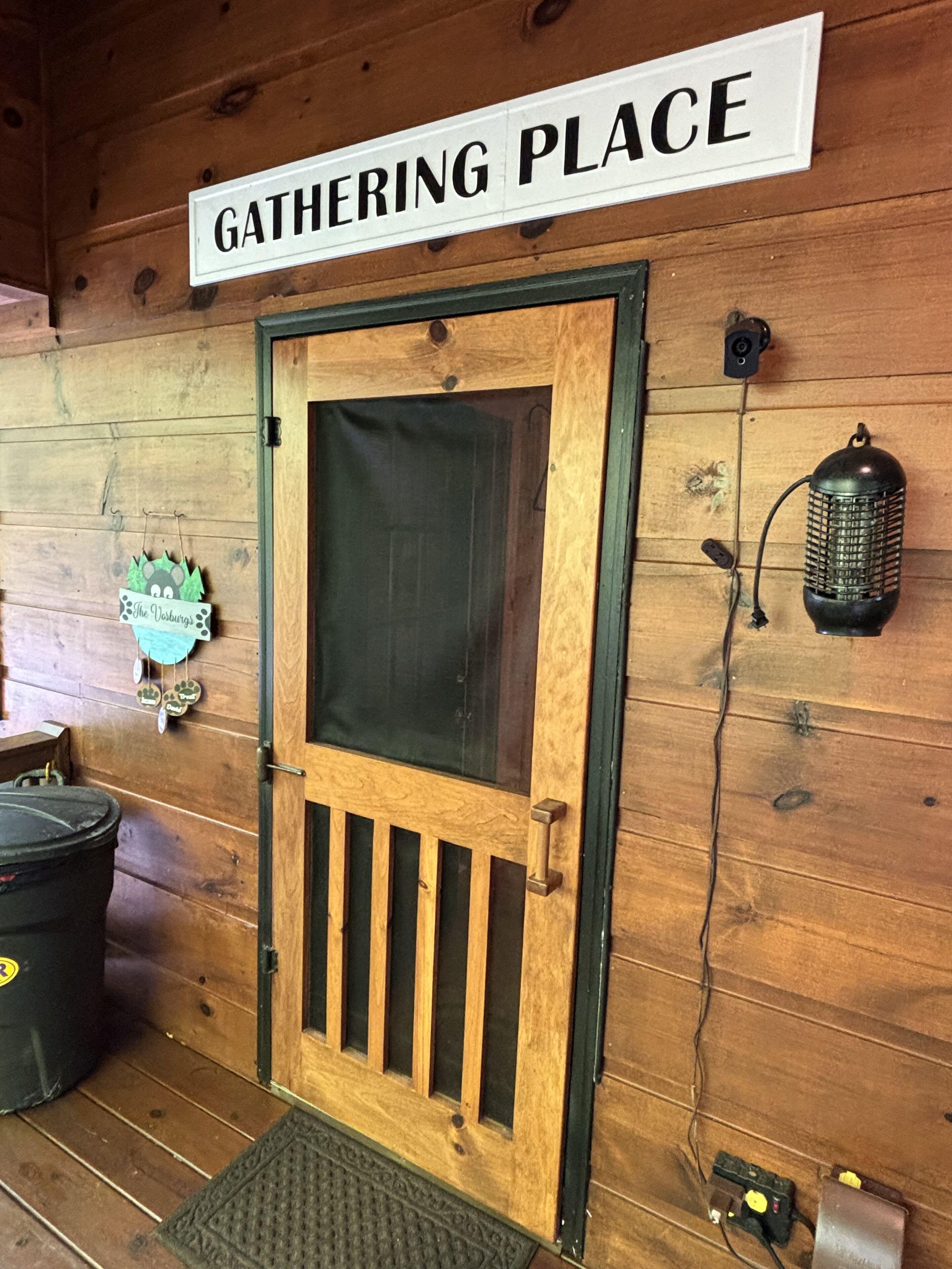 A wooden door with a sign above it reading "GATHERING PLACE".
