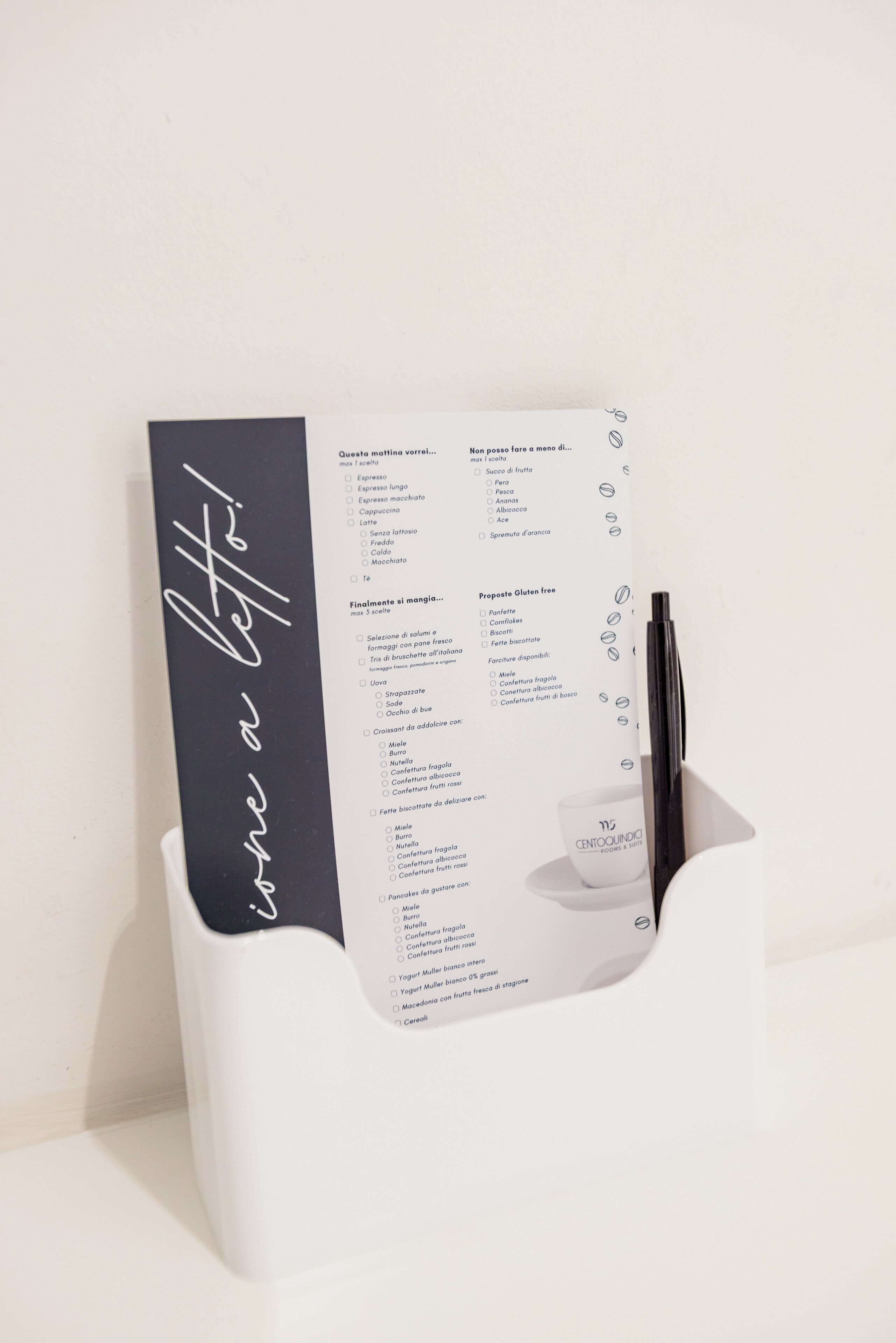 A menu with various food options, including gluten-free choices, in a holder.