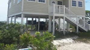A two-story house with a balcony and a staircase leading to the upper level.