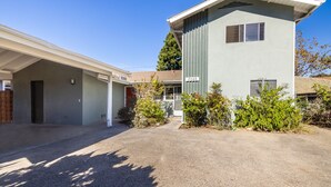 A two-story building with a garage and a covered driveway. - Two Bedroom Home Near Beach (Santa Barbara) (Santa Barbara)