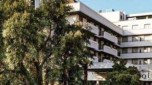 A multi-story hotel with balconies and a sign reading "QUARK HOTEL MILANO". - Quark Hotel Milano (Milan)