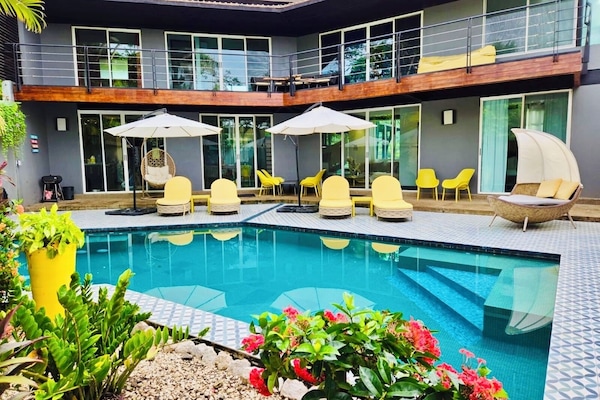 Backyard with pool, cabana, and lots of options for sun or shade.