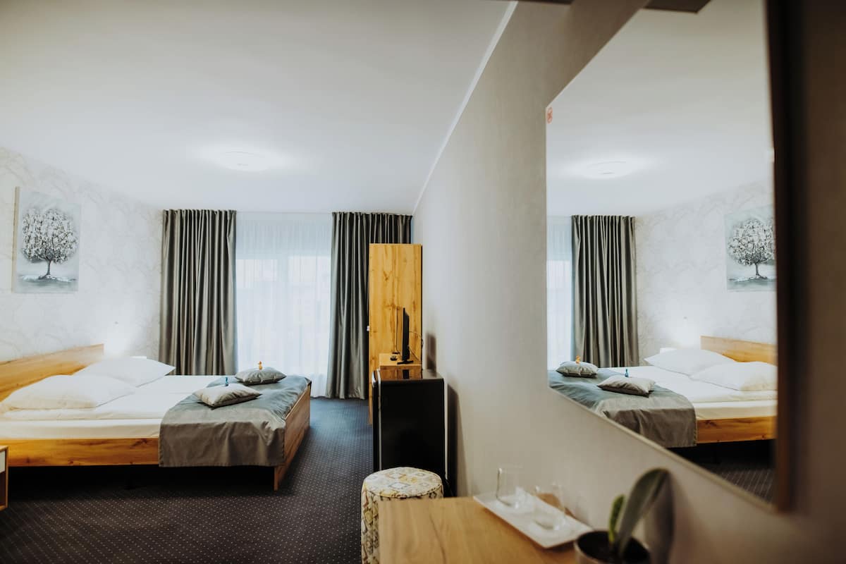 Triple Room | 1 bedroom, down comforters, in-room safe, blackout drapes