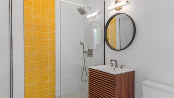 Shower, rainfall showerhead, designer toiletries, hair dryer at Limon Palm Springs