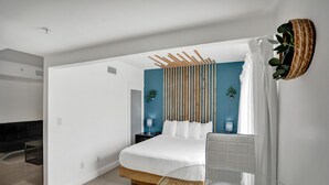 A modern bedroom with a large bed, wooden headboard, bedside tables, and a glass table. - NEW LISTING! Premium 2 bedroom/2bathroom Sleeps 7 (Miami)