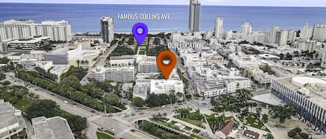 A cityscape with a prominent building labeled 'Famous Collins Ave' and another labeled 'Our Location'.