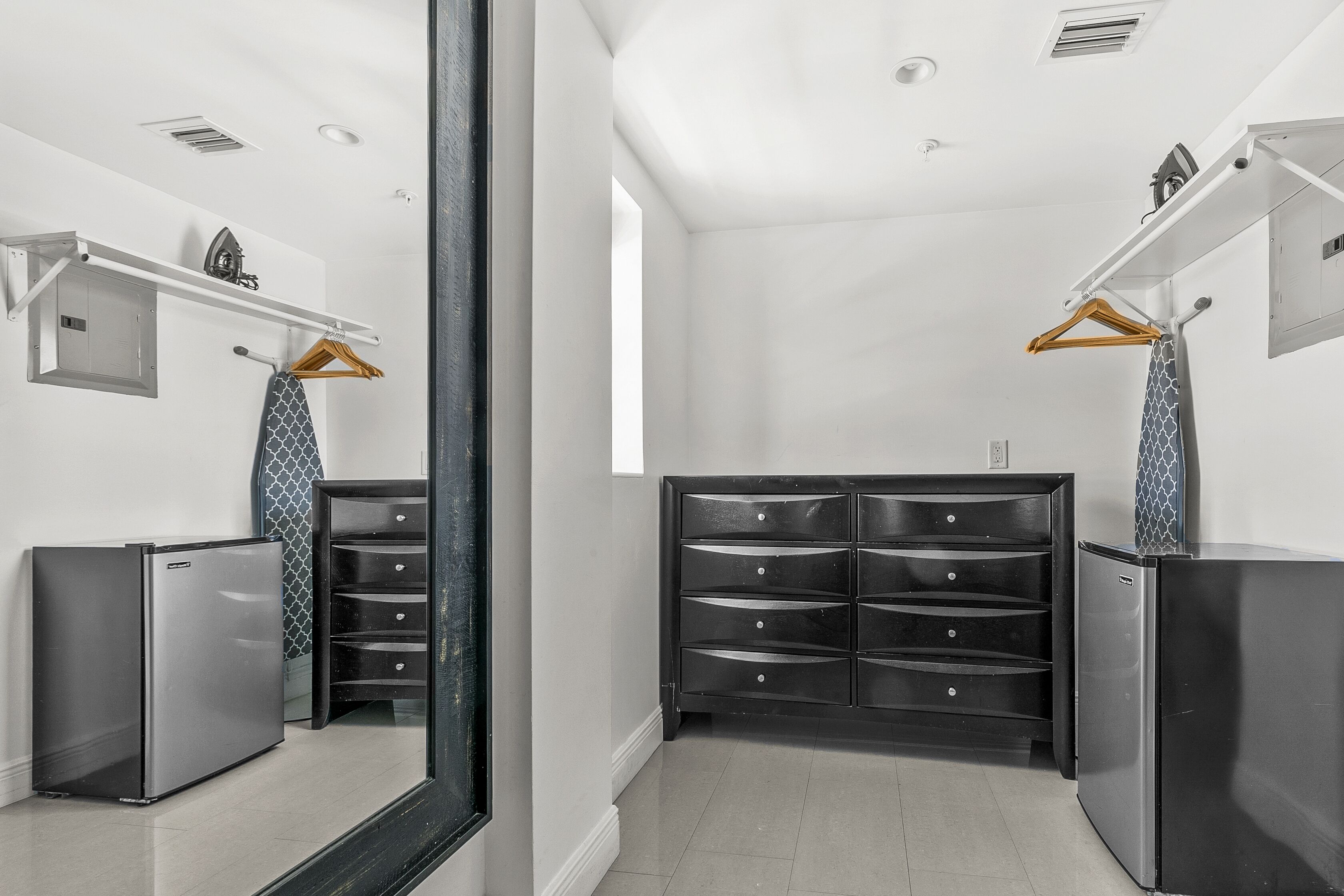 A modern bathroom with a walk-in shower, a built-in toilet, and a vanity with a mirror.