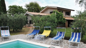 A swimming pool with lounge chairs and a stone patio. - Villa Il Casolare Country House With Pool on Sperlonga's Hill (Itri)