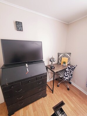 A room with a black dresser, a desk with a patterned chair, a small globe, and a framed quote on the wall. - Room-black-white Rm By Yale U (New Haven)