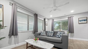 A modern living room with a grey sofa, a marble coffee table, and grey curtains. - Casa Cordova by Lowkl (Fort Lauderdale)