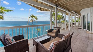 A covered outdoor area with wicker furniture and a view of the ocean. - Private Pool, Sun Deck, Cliffside, Ocean Views, AC (St. Thomas)