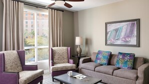 A hotel room with two armchairs, a sofa, a coffee table, a lamp, and a window with curtains. - 2 Bed 2 Bath Las Vegas - Pools, Hot Tubs, Cabanas and More! (Las Vegas)