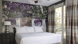 A neatly made bed with white linens, a dark nightstand with drawers, a wall-mounted lamp, and a large window with curtains. - 2 Bed 2 Bath Las Vegas - Pools, Hot Tubs, Cabanas and More! (Las Vegas)
