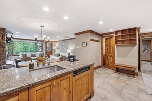 A kitchen with granite countertops, wooden cabinets, and a built-in dishwasher. - Lodge Tower 294 2BR at the base of Vail Mountain (Vail)