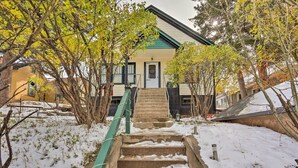 A house with a front porch, a staircase leading to the door, and snow on the ground. - Mountain-View Lead Home w/ Patio + Fire Pit! (Lead)
