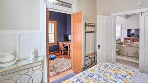 A bedroom with a bed, a desk, and a chair. There is a wardrobe and a television in the room. - Mountain-View Lead Home w/ Patio + Fire Pit! (Lead)