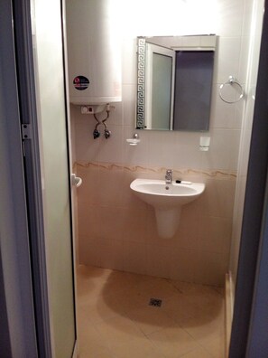 A small bathroom with a sink, mirror, and towel rack. - Silver Beach B16 Apartment (Byala)