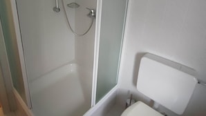 A bathroom with a glass-enclosed shower, a white toilet, and a white sink. - Room in Guest Room - Pension Forelle - Doppelzimmer (Forbach)