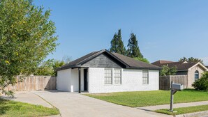 Een gelijkvloers huis met garage, voortuin en brievenbus.