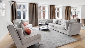 A modern living room with a sofa, armchair, and a coffee table. - Regent 1 - Lovely 2-bdr Apt w Terrace (Copenhagen)