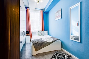 Relax in a stylish room with a large bed, nightstand, and framed artwork.
