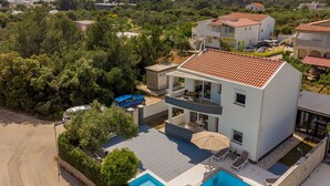 A modern two-story house with a swimming pool, surrounded by greenery and a view of the sea. - Villa Julija (Sukosan)