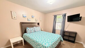 A bedroom with a bed, a nightstand, a TV, and a window with curtains. - ENTIRE Place 2 Bed 2 Bath. Everything You Need for a Hassle-Free Stay in Biloxi. (Biloxi)