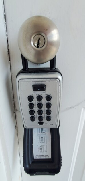 A door lock with a keypad and a keyhole.